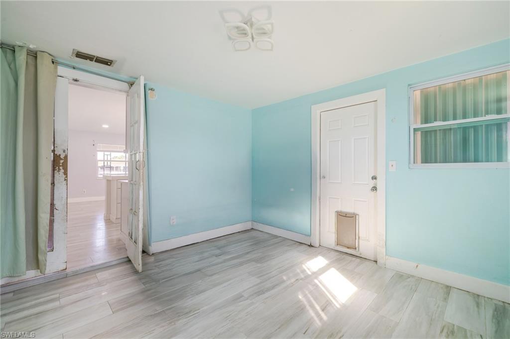 339 Beachwood Road Lehigh Acres, FL 33936 - Photo 20 of 32 Unfurnished room with baseboards and light wood-style floors