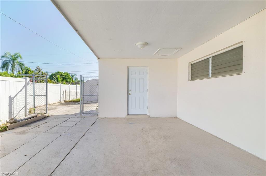 339 Beachwood Road Lehigh Acres, FL 33936 - Photo 23 of 32 View of patio featuring a gate