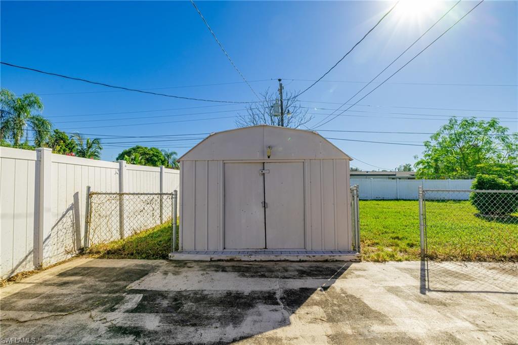 339 Beachwood Road Lehigh Acres, FL 33936 - Photo 26 of 32 View of shed featuring a fenced backyard