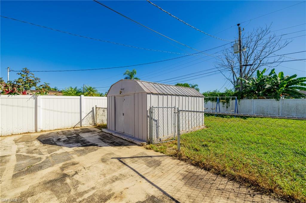 339 Beachwood Road Lehigh Acres, FL 33936 - Photo 27 of 32 View of shed featuring a fenced backyard