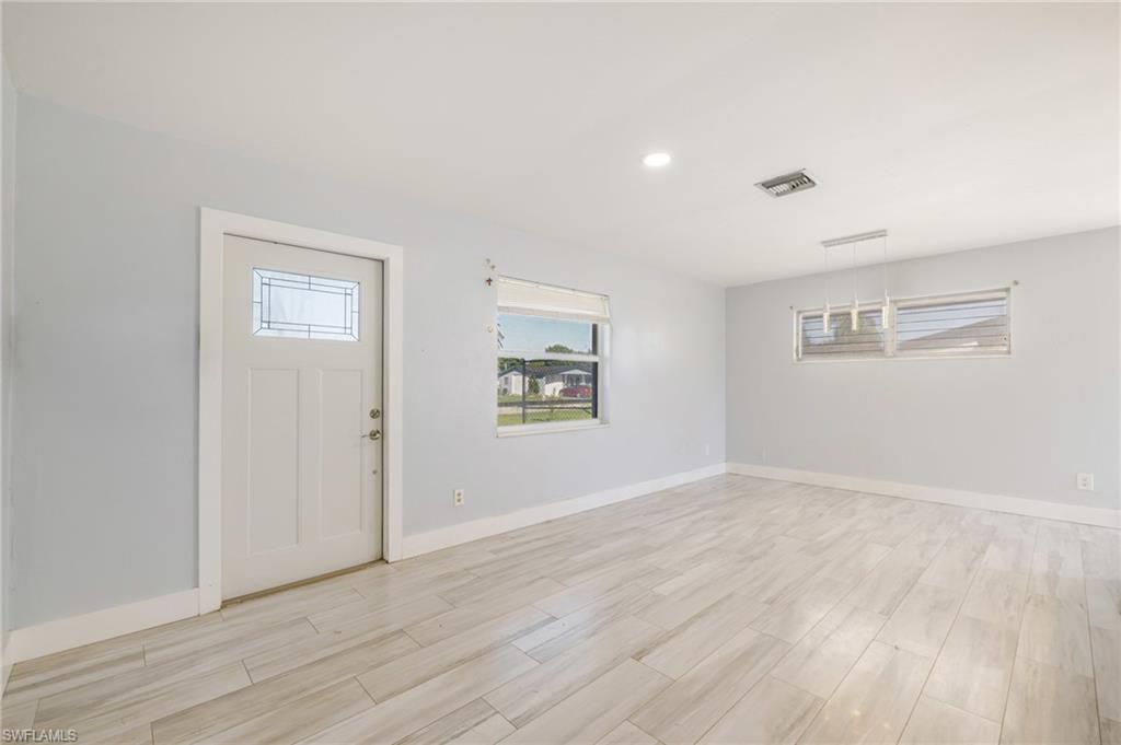 339 Beachwood Road Lehigh Acres, FL 33936 - Photo 7 of 32 Entryway featuring recessed lighting and light wood-style flooring