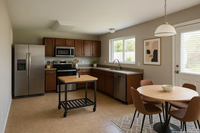 a kitchen with a sink stove a refrigerator and a granite counter top