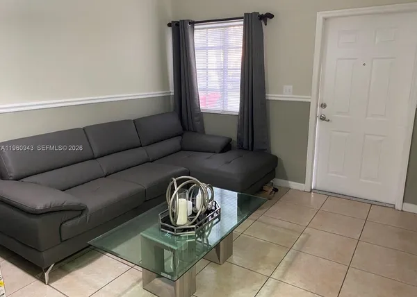 a living room with furniture and a window