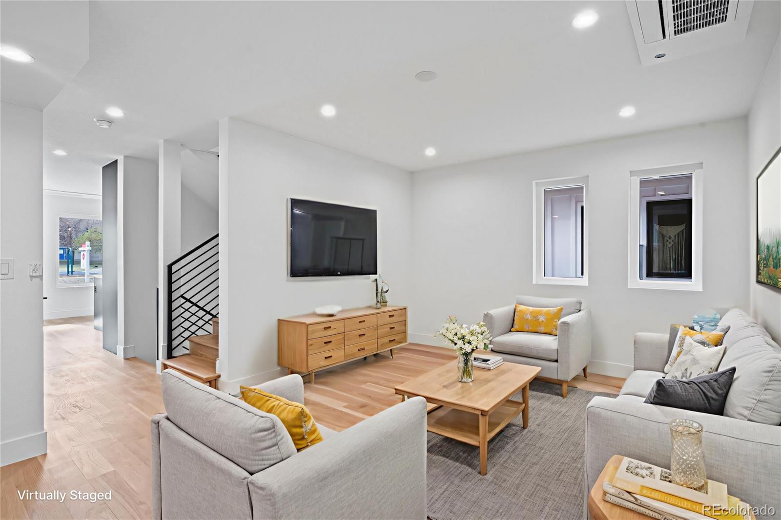 a living room with furniture and a flat screen tv