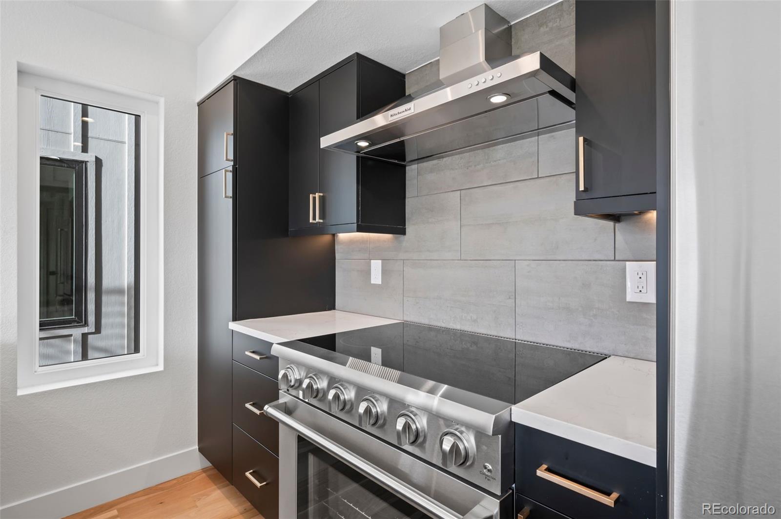 2453 Lawrence Street, Unit 1 Denver, CO 80205 - Photo 11 of 48 a kitchen with a stove and a cabinet
