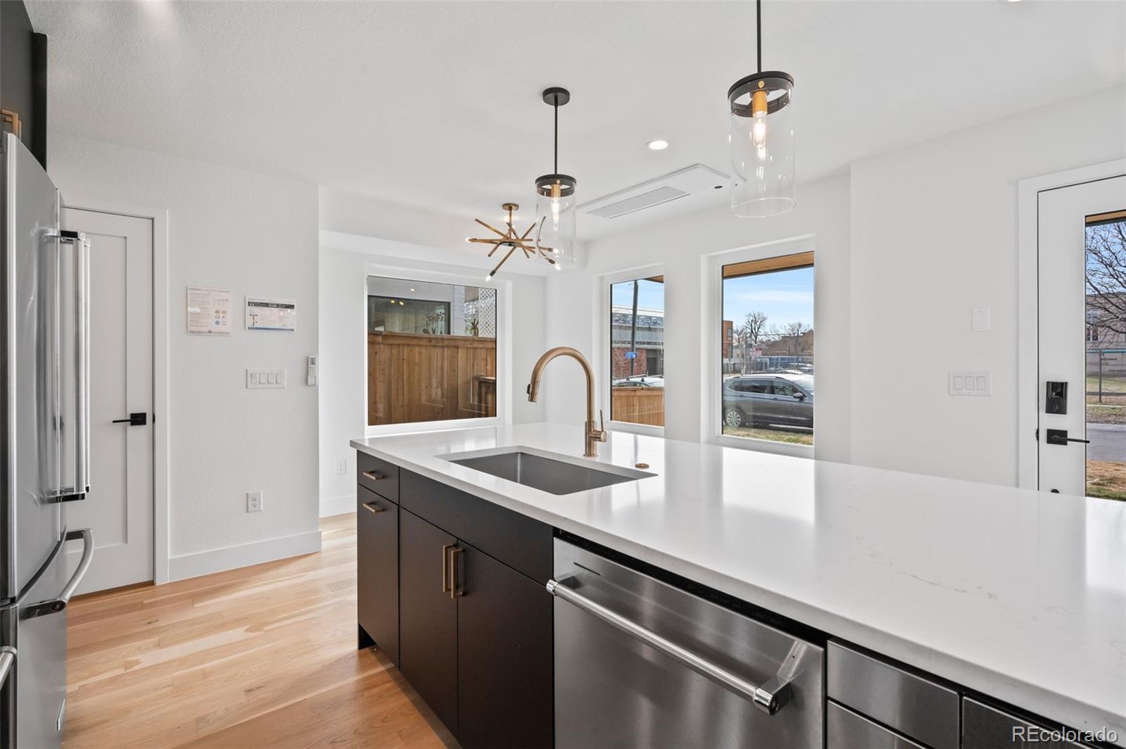 2453 Lawrence Street, Unit 1 Denver, CO 80205 - Photo 13 of 48 a view of a kitchen with a sink and refrigerator