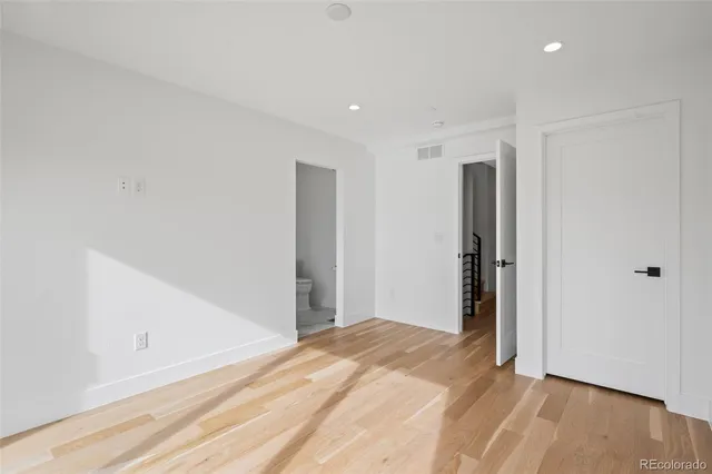 a view of hallway with wooden floor