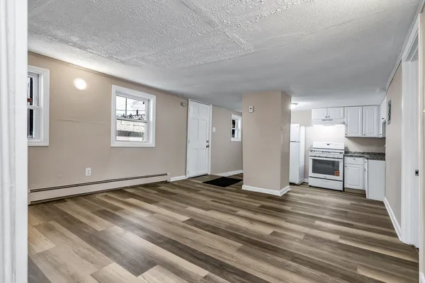 a view of a kitchen with wooden floor and a kitchen