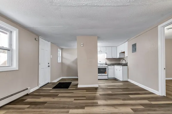 a kitchen with white cabinets and appliances