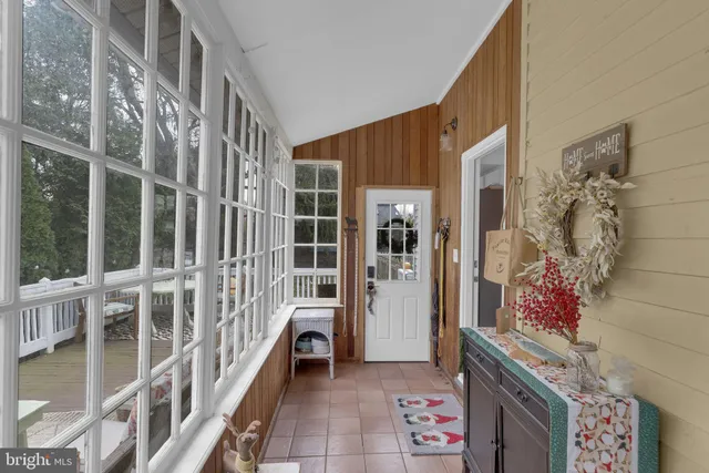a view of a patio with couches table and chairs and potted plants