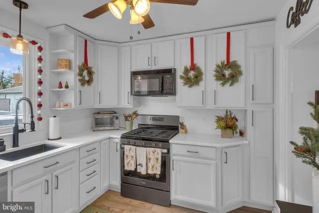 a kitchen with stainless steel appliances white cabinets and a stove