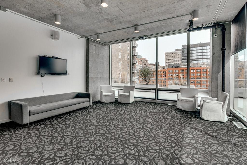 611 South Wells Street, Unit 809 Chicago, IL 60607 - Photo 13 of 14 a living room with furniture and a flat screen tv