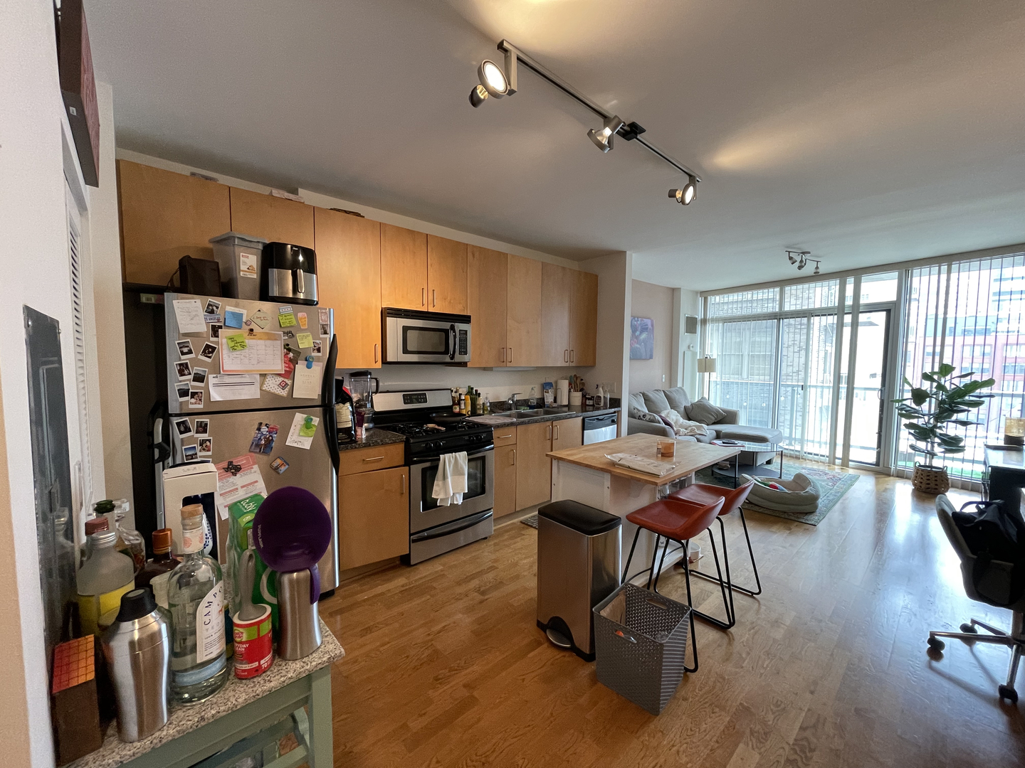 611 South Wells Street, Unit 809 Chicago, IL 60607 - Photo 2 of 14 a workspace with kitchen view and a wooden floor