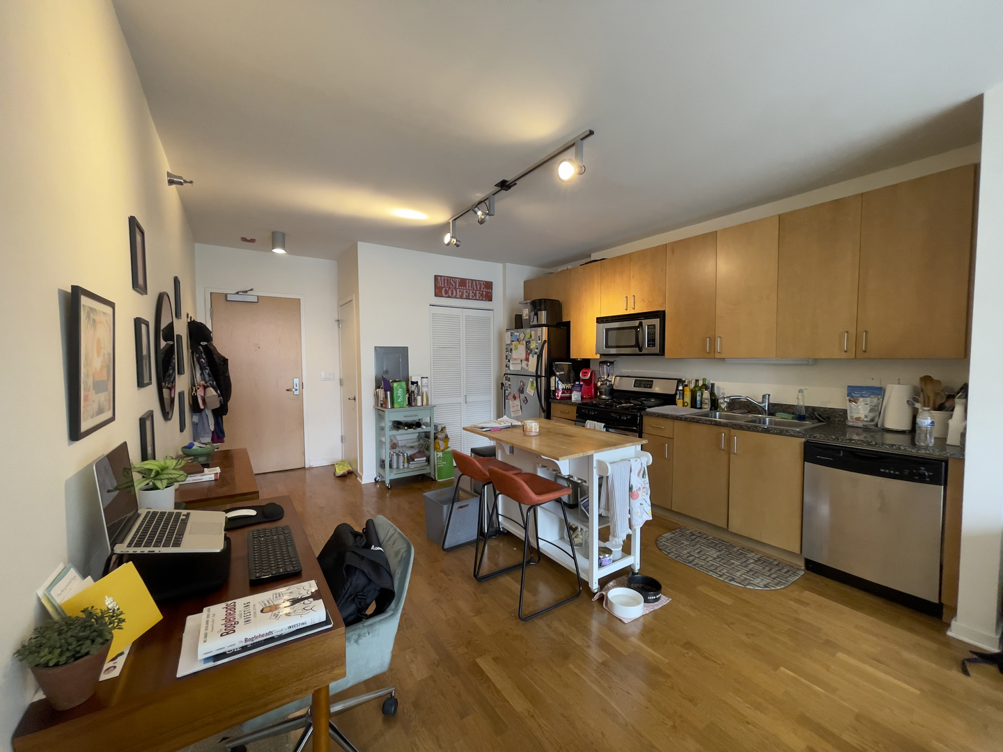 611 South Wells Street, Unit 809 Chicago, IL 60607 - Photo 3 of 14 a living room with furniture kitchen view and a wooden floor