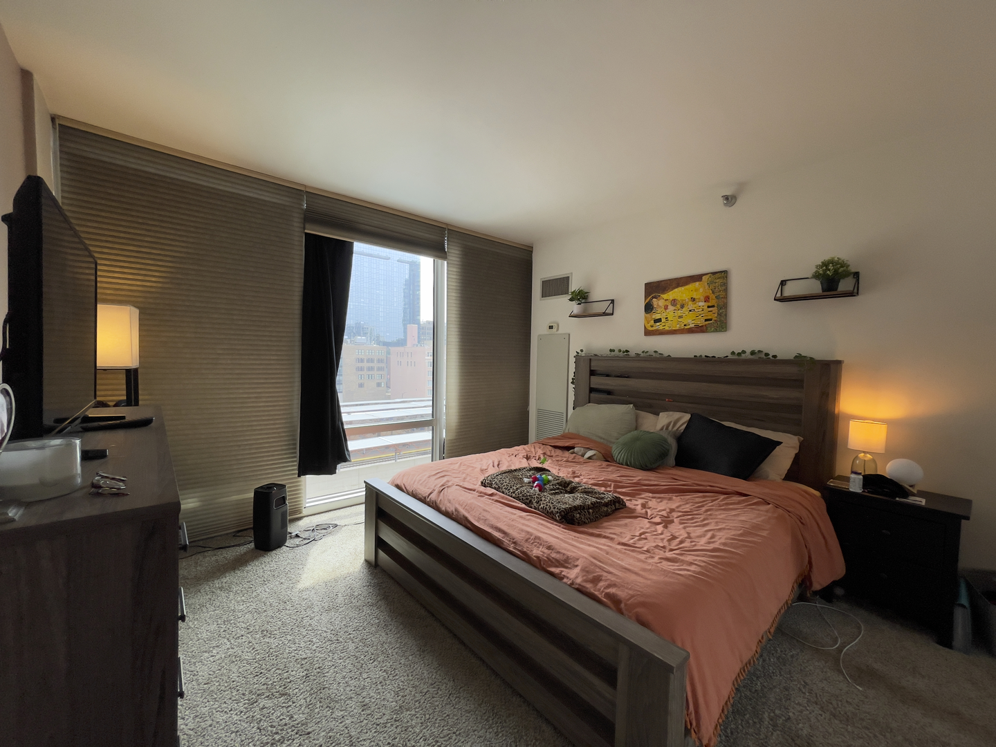 611 South Wells Street, Unit 809 Chicago, IL 60607 - Photo 7 of 14 a bedroom with a bed and a flat screen tv
