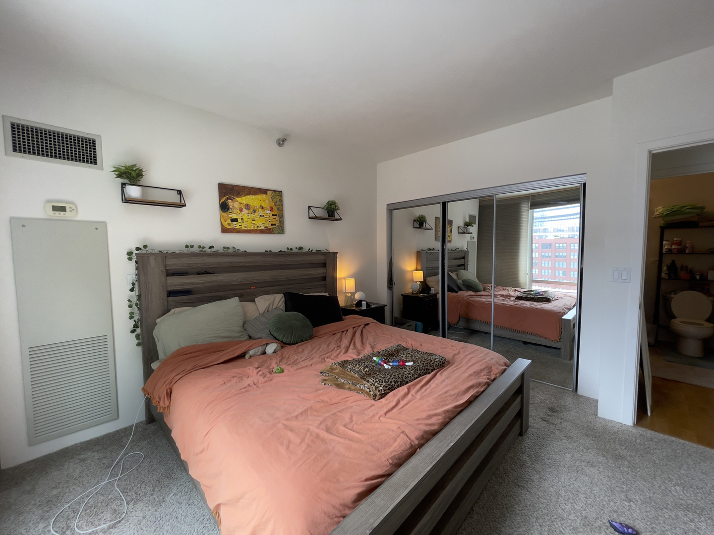 611 South Wells Street, Unit 809 Chicago, IL 60607 - Photo 8 of 14 a bedroom with a bed and wooden floor