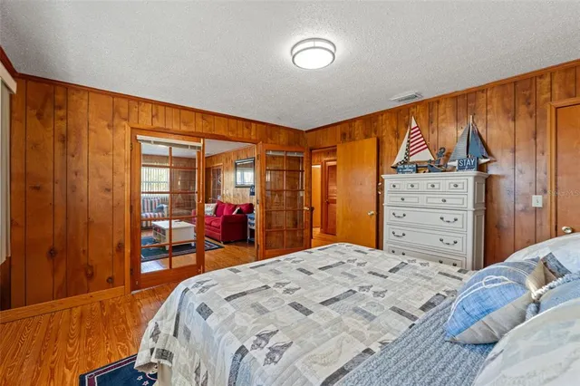 a bedroom with a large bed and a window