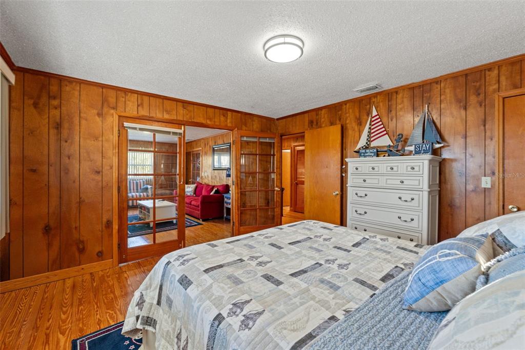 3461 Gum Drive Weeki Wachee, FL 34607 - Photo 22 of 48 a bedroom with a bed and wooden floor