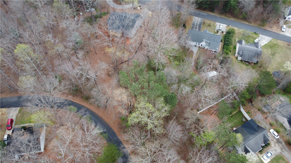 This property offers a serene, wooded setting for your future home.