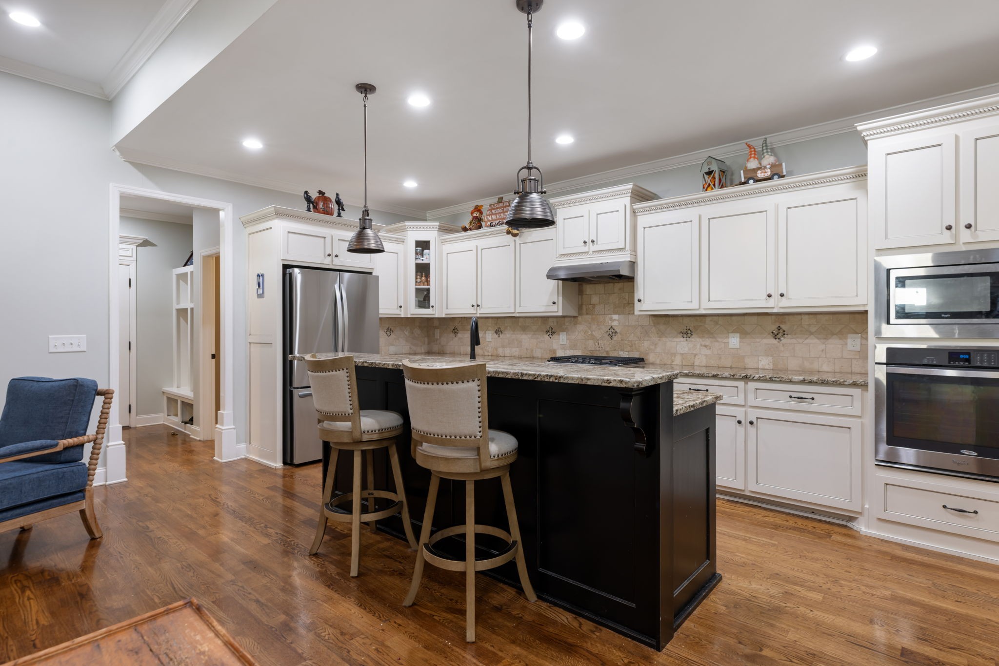 4120 Turnberry Road Spring Hill, TN 37174 - Photo 22 of 48 a kitchen with stainless steel appliances kitchen island granite countertop a table chairs sink and cabinets