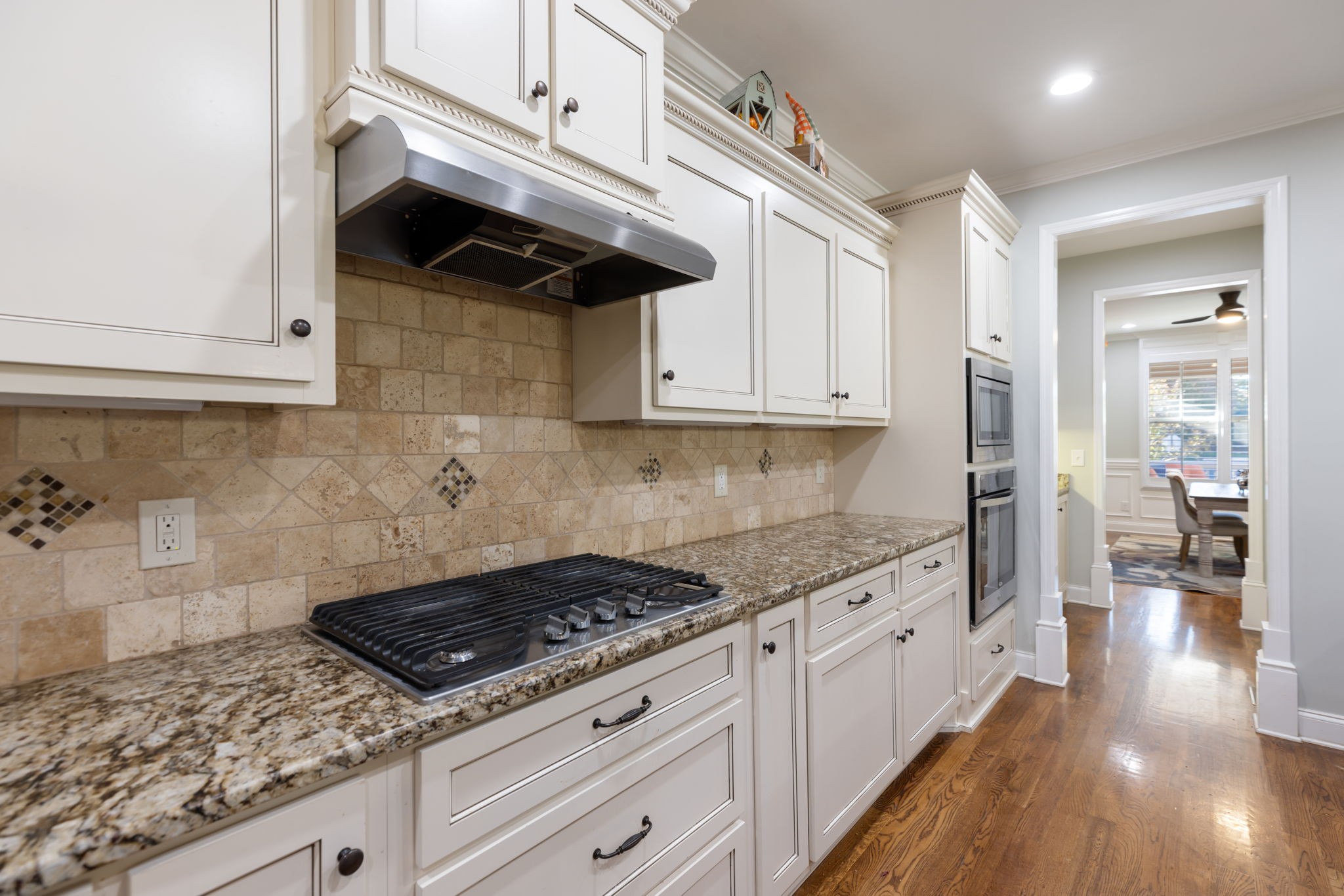 4120 Turnberry Road Spring Hill, TN 37174 - Photo 25 of 48 a kitchen with granite countertop a stove and white cabinets
