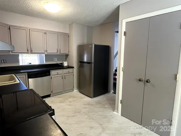 a kitchen with a refrigerator and a sink