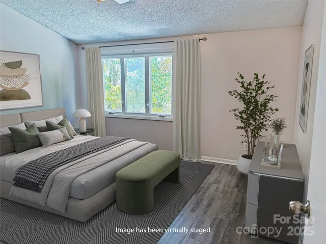 a bed sitting in a bedroom next to a window