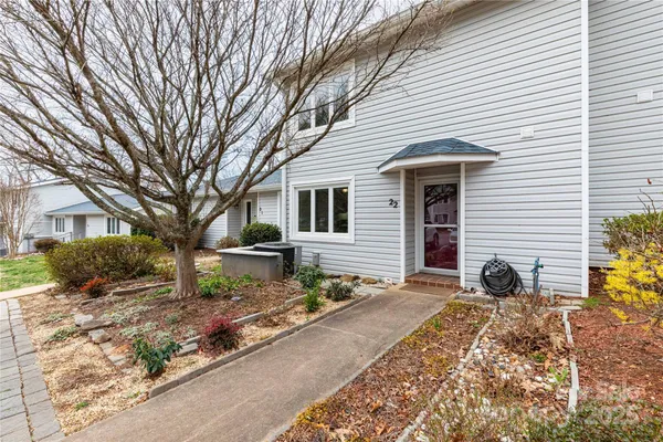 a view of a house with backyard and trees