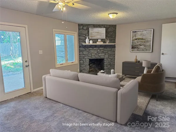 a living room with furniture and a fireplace