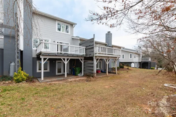 a view of a house with yard and sitting area