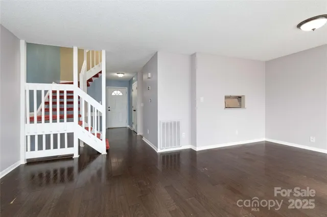 a view of an entryway with wooden floor