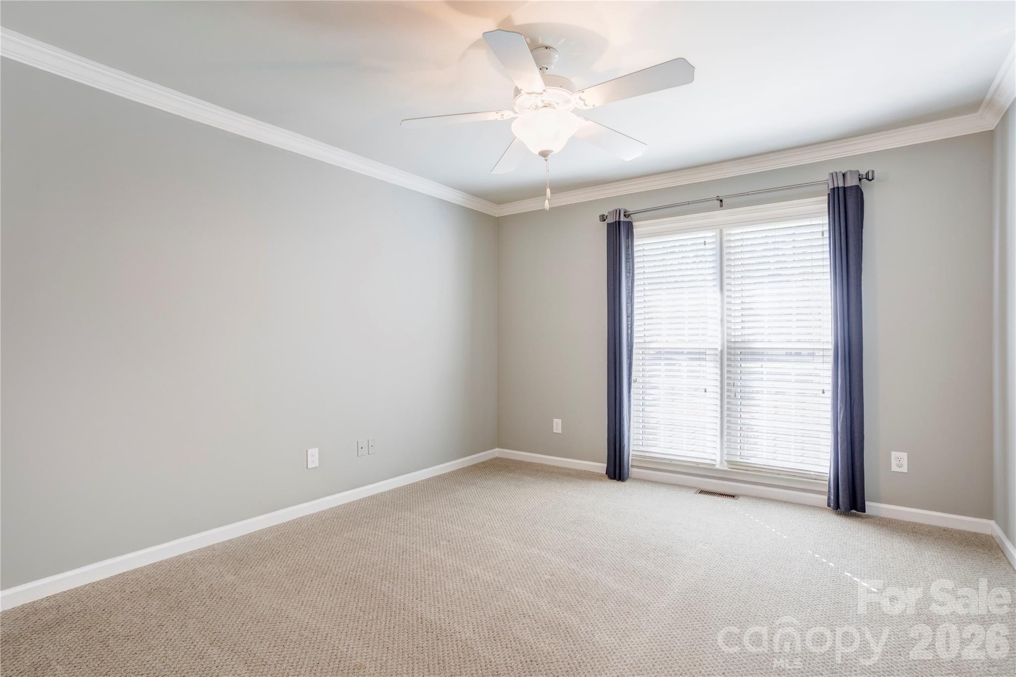 1188 Fawn Ridge Road Northwest Concord, NC 28027 - Photo 24 of 38 an empty room with windows and chandelier fan