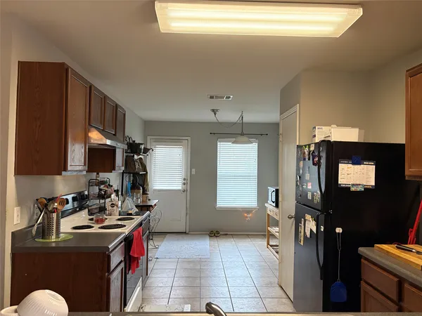a kitchen with a sink cabinets and appliances