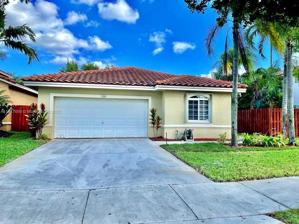 a front view of a house with a yard and garage