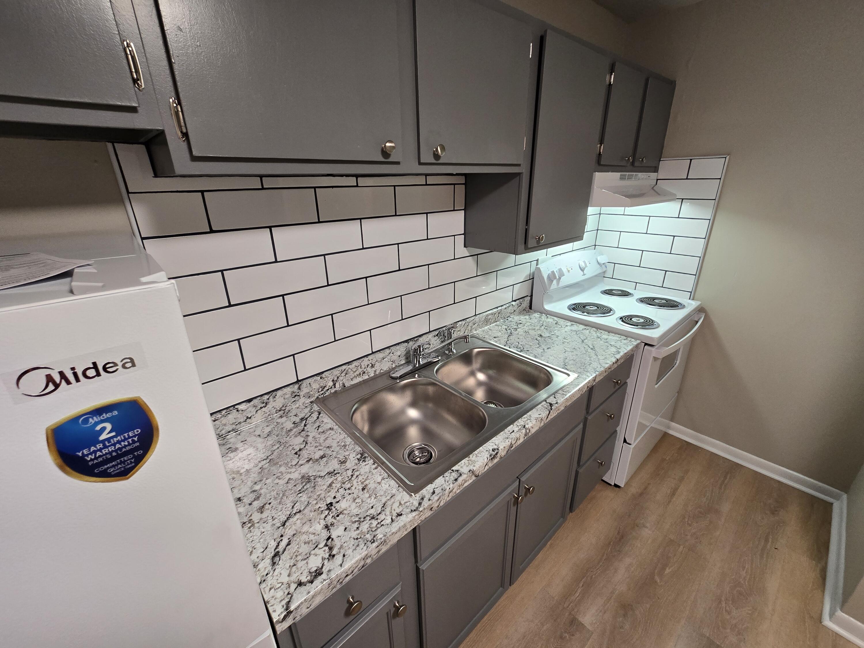 2632 Westover Avenue Southwest, Unit 11 Roanoke, VA 24015 - Photo 3 of 9 a kitchen with stainless steel appliances granite countertop a sink stove and cabinets