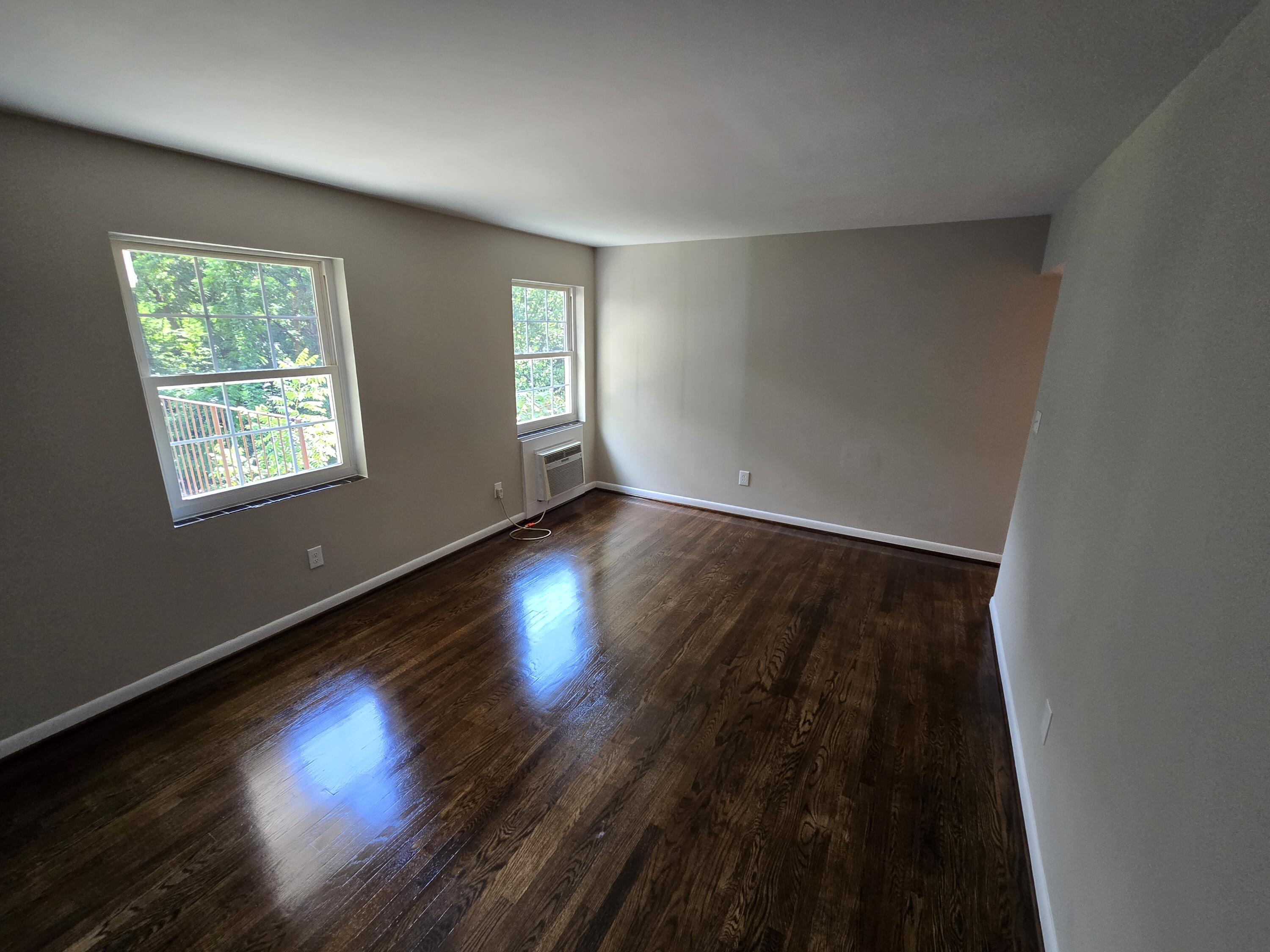 2632 Westover Avenue Southwest, Unit 11 Roanoke, VA 24015 - Photo 4 of 9 a view of an empty room with wooden floor and a window