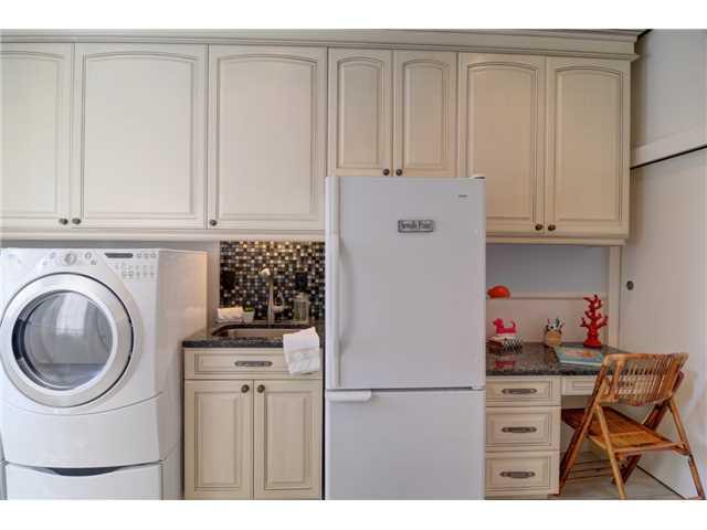 41 West High Point Road Stuart, FL 34996 - Photo 9 of 25 a kitchen with a refrigerator and white cabinets