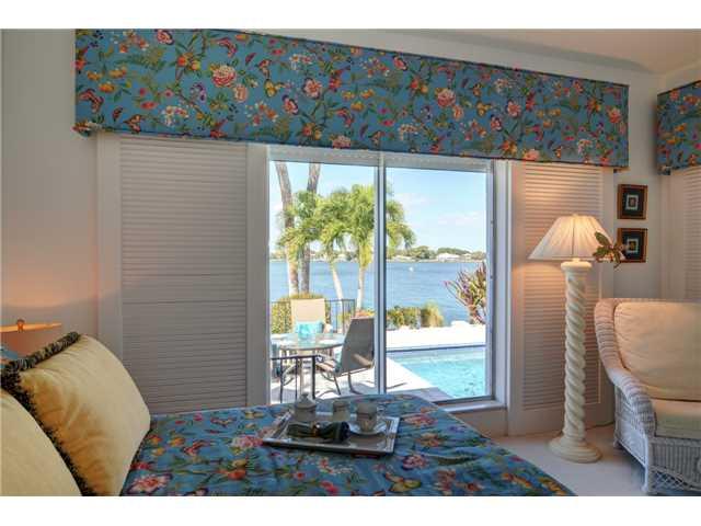 41 West High Point Road Stuart, FL 34996 - Photo 10 of 25 a living room with furniture and a floor to ceiling window