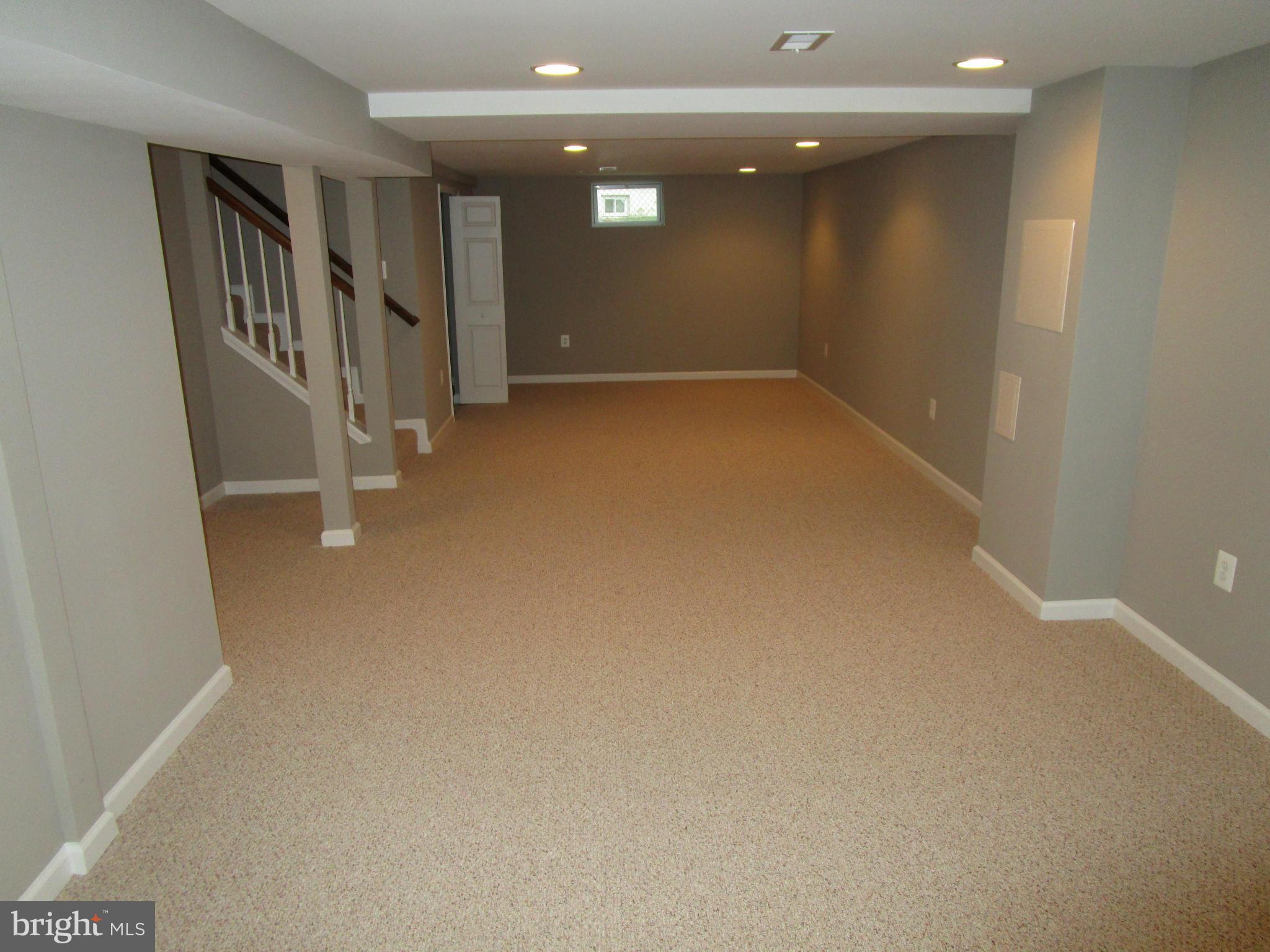 12704 Holdridge Road Silver Spring, MD 20906 - Photo 13 of 22 wooden floor in an empty room with stairs