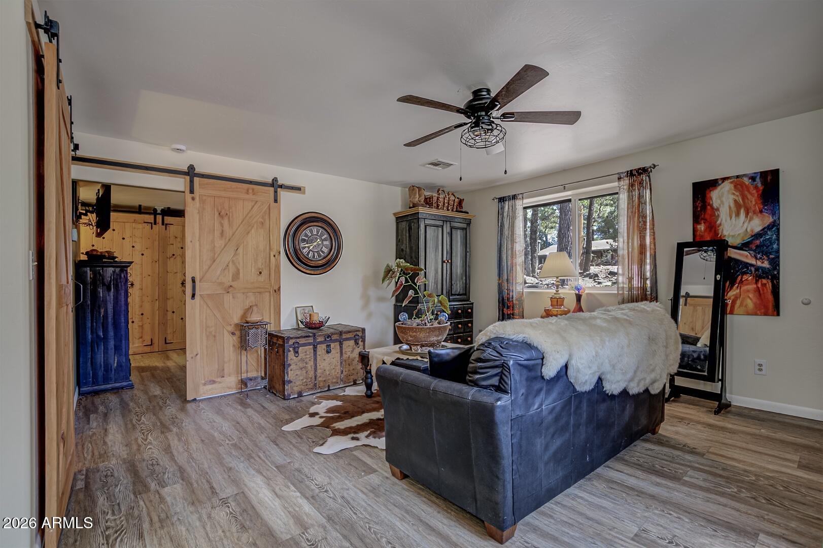 3762 Watertank Road Pine, AZ 85544 - Photo 5 of 38 a living room with furniture and a wooden floor
