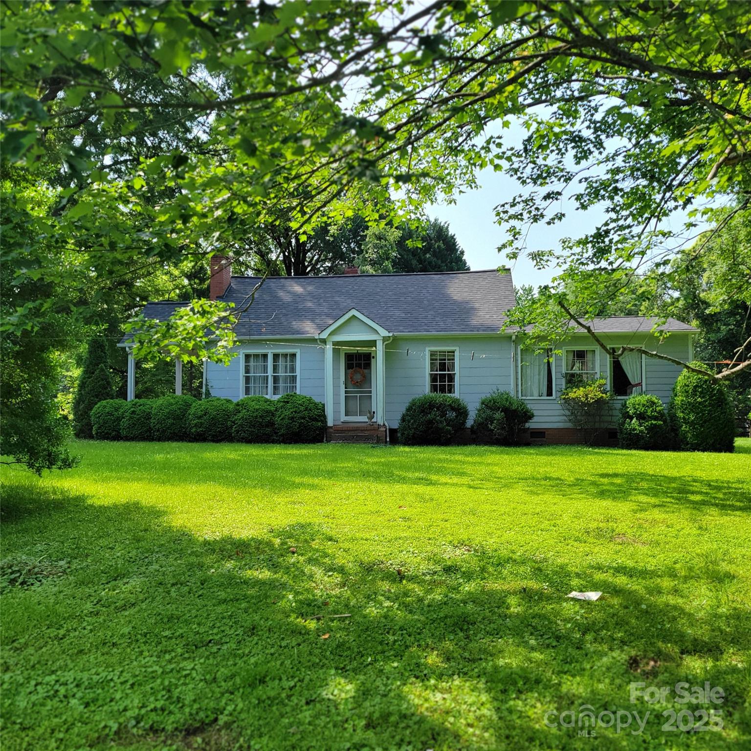 6908 Alexander Road Charlotte, NC 28270 - Photo 1 of 3 a front view of a house with a garden