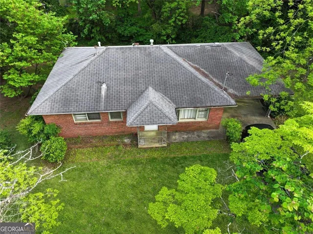 an aerial view of a house with a yard