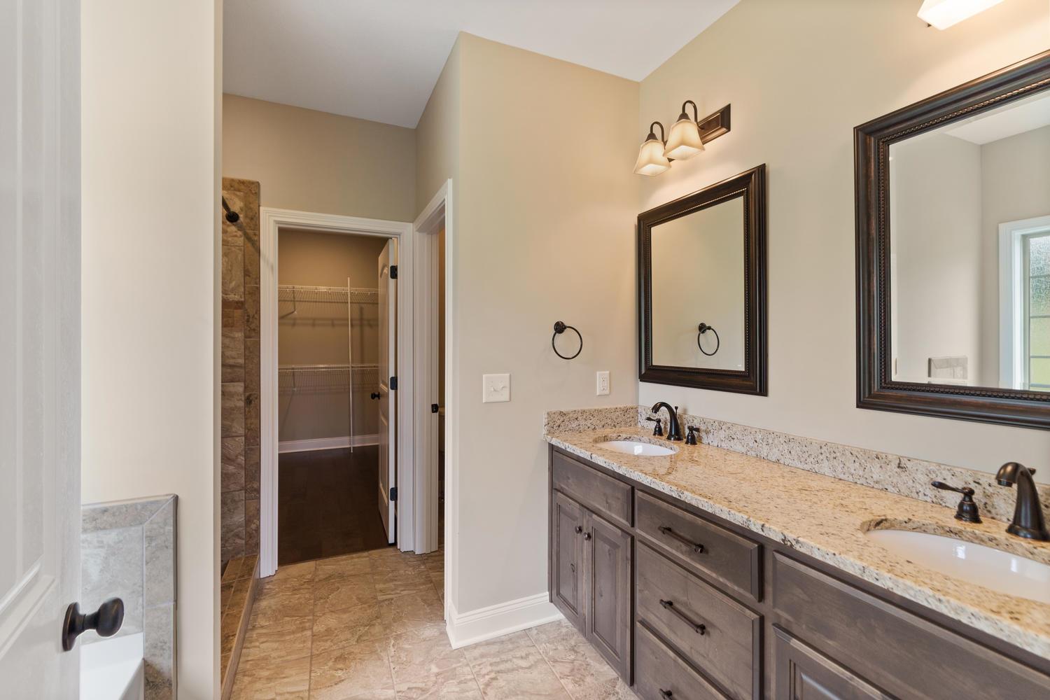 4347 Memory Lane Adams, TN 37010 - Photo 16 of 30 a bathroom with double vanity sinks and a mirror