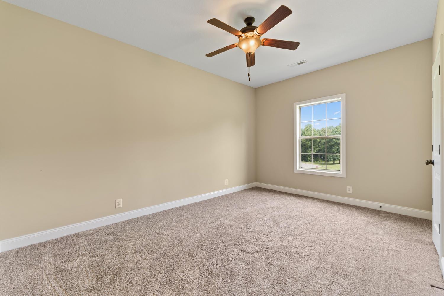 4347 Memory Lane Adams, TN 37010 - Photo 24 of 30 an empty room with a window and a fan