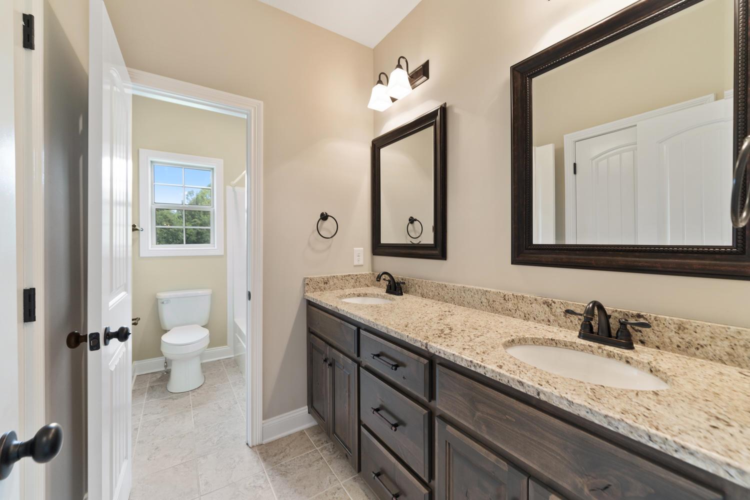4347 Memory Lane Adams, TN 37010 - Photo 26 of 30 a bathroom with a granite countertop sink double and mirror