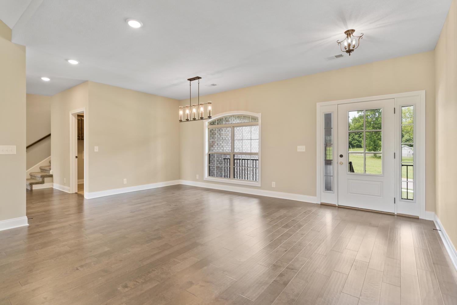 4347 Memory Lane Adams, TN 37010 - Photo 5 of 30 a view of an empty room with wooden floor and a window