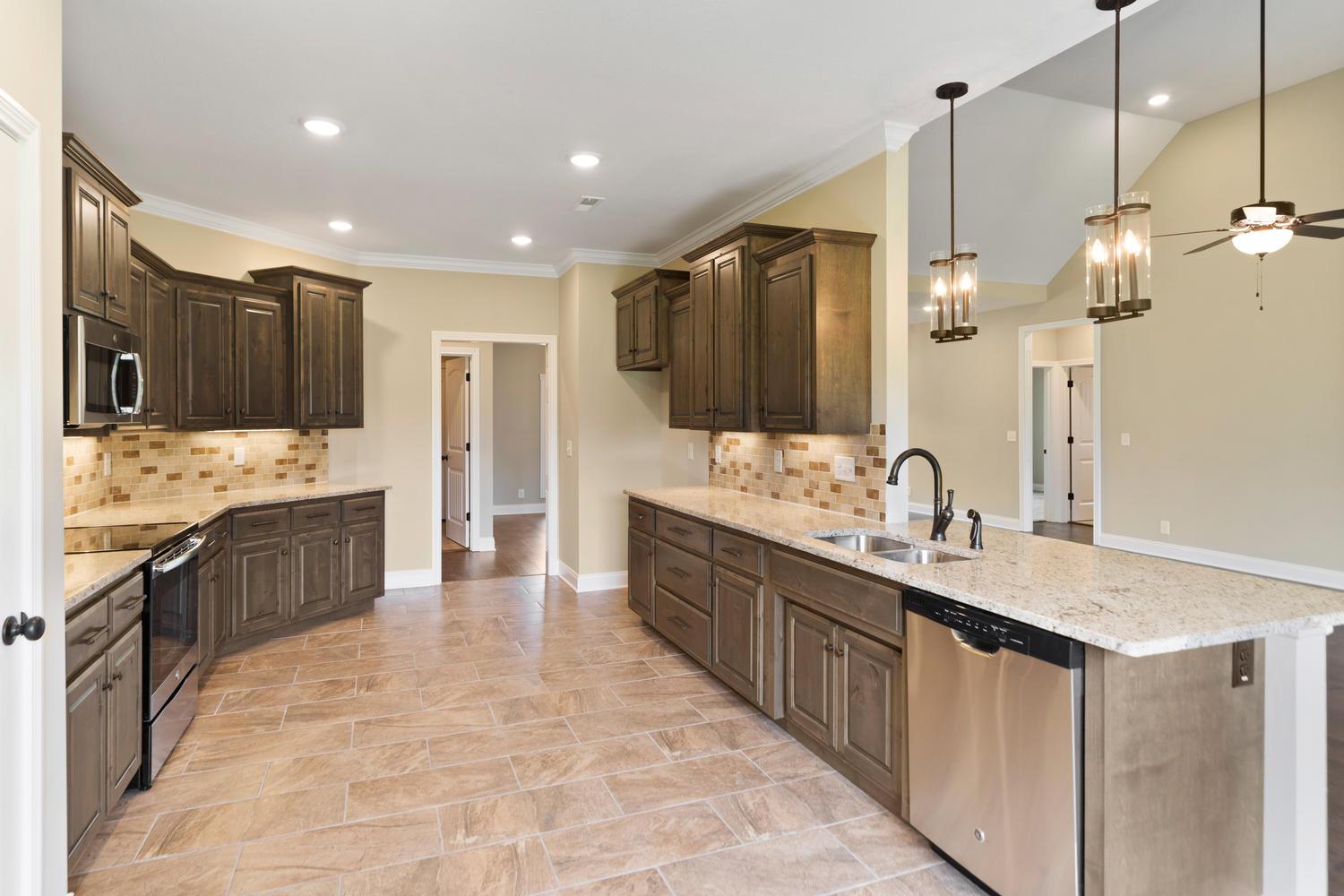 4347 Memory Lane Adams, TN 37010 - Photo 10 of 30 a large kitchen with kitchen island granite countertop a sink and a wooden floor