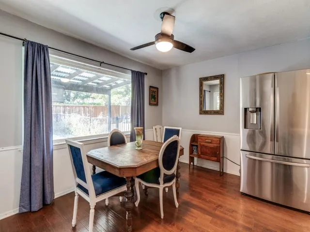 a dining room with furniture window and wooden floor