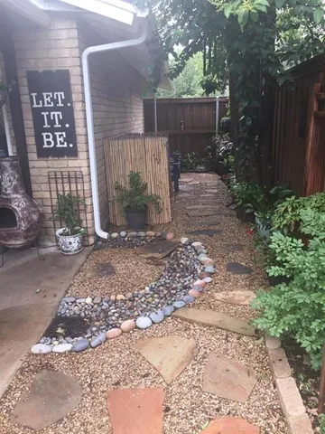 a view of a backyard with wooden fence