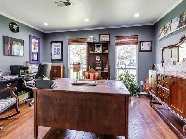 a living room with furniture a flat screen tv and a large window